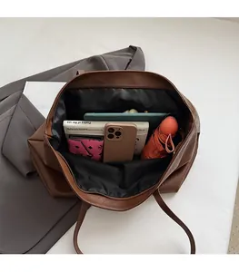 Macro shot of spacious inner compartment of the brown tote bag holding daily essentials