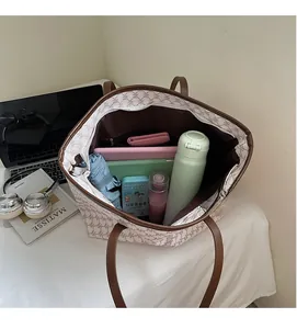 Detail view of large tote bag interior showing capacity for tablet, umbrella and folders