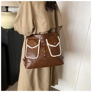 Retro dark brown crossbody bag featuring white faux fur trim and vintage metal rivets