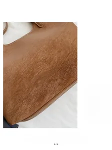 Detail of brown leather tote bag with white stitching and Fashion & Bags text