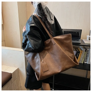 Brown vintage faux leather tote bag with large capacity shown in office setting