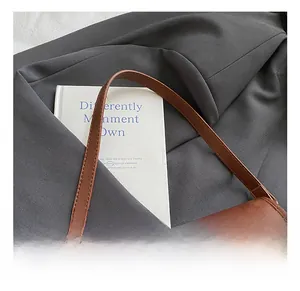 Detailed view of brown retro PU leather underarm bag featuring fine edge stitching and flap