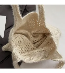Close-up of the open-top design and spacious interior of this knit crochet tote bag
