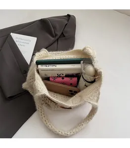 Detail view of large capacity beige cable knit tote bag showing spacious inner compartment