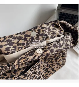 Detailed close-up of leopard print tote bag featuring a secure magnetic snap closure
