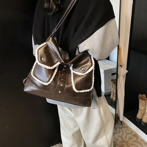 Brown leather tote bag with white fleece trim pockets and vintage silver studs