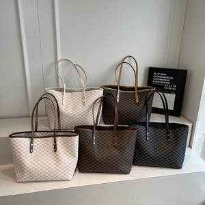 Row of large tote bags featuring classic monogram patterns in various colors for daily use