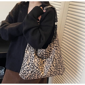 Close-up of stylish leopard print crossbody tote bag showing large capacity and strap detail