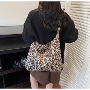 Detailed view of hobo leopard print tote bag on shoulder for fashion styling