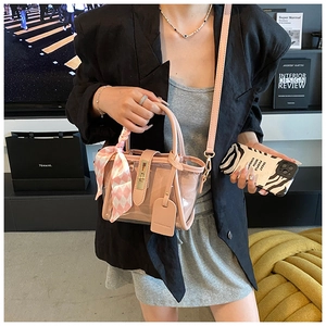 Pink transparent PVC bucket bag detail with interior pouch and silk scarf handle decor