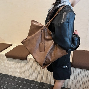 Brown retro large capacity leather tote bag for women showing a stylish shoulder design