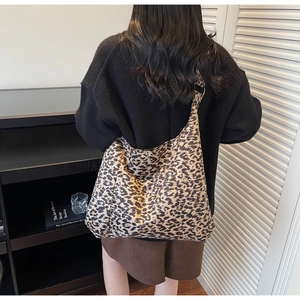 Leopard print crossbody tote bag shown on model highlighting its large capacity and style