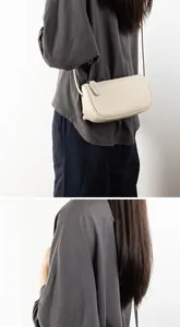 Minimalist cream leather crossbody bag shown on model for a stylish daily commute look