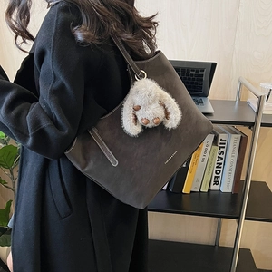 Modern grey tote bag with plush bunny charm and Fashion & Bags text on shoulder