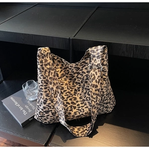 Detailed macro view of high-capacity leopard print tote bag with silver metal buckle