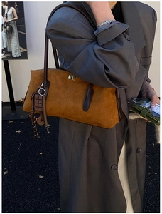 Caramel suede shoulder bag with deep brown leather strap and chocolate charm detail