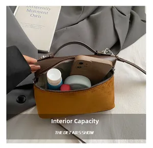 Interior view of the vintage suede box bag showing capacity for phone and cosmetics
