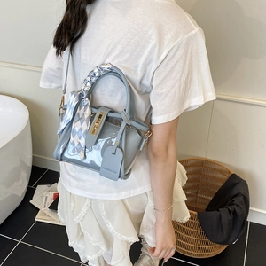 Light blue transparent PVC bucket bag with silk scarf handle and gold hardware detail