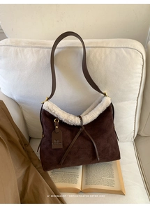 Dettaglio borsa a tracolla in pelle scamosciata marrone con bordo in lana e goffratura retro