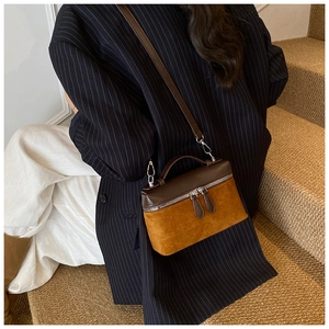 Detail view of retro square crossbody bag in brown and mustard yellow faux leather