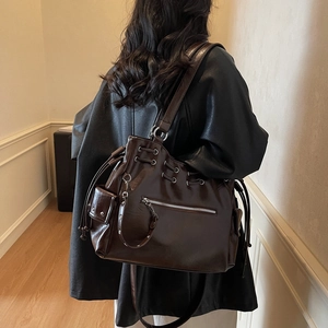 Glossy dark brown faux leather tote bag with drawstring detail for daily fashion wear