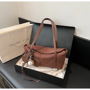 Brown suede shoulder bag with baseball charm in an elegant gift box with white satin lining