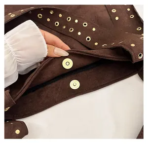 Detail shot of brown suede bag featuring gold rivets and magnetic metal snap closure