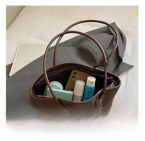 Macro detail of the woven brown tote bag interior showcasing its large storage capacity