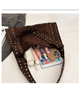 Interior view of brown suede hobo bag showing large capacity for tablet and umbrella