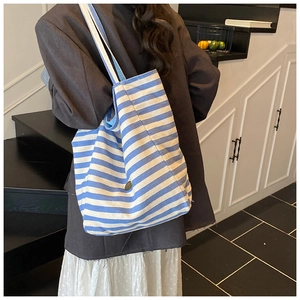 Detail of blue and white striped canvas tote bag showing textured fabric and large capacity