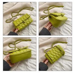 Detail view of lime green quilted handbag with chain strap and gold twist lock clasp