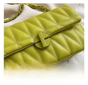 Detail of lime green quilted chain bag showing geometric stitching and matte hardware