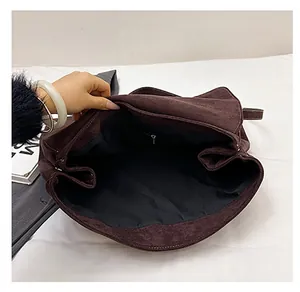 Macro view of the spacious interior compartment with dark lining and a zipper pocket