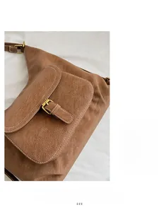 Detailed macro view of brown lychee-textured leather and premium metal buckle closure