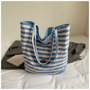 Detail view of large capacity blue and white striped tote bag with handmade label