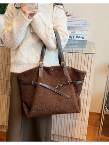 Close-up of deep brown fuzzy lamb wool tote bag with premium leather buckle straps