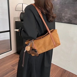 Vintage brown suede tote bag with leather straps and GLEAMOK logo in a lifestyle setting