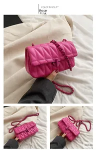 Macro shot of rose pink quilted leather chain bag with elegant cross-knob lock detail