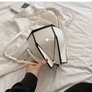 Detail view of the geometric paneled back and slim strap on this monochrome bucket bag