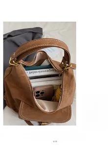 Detailed interior of a brown matte tote bag showing large capacity for books and phone