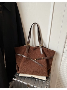 Détail du cabas en peluche marron foncé avec sangle en cuir et boucle en métal