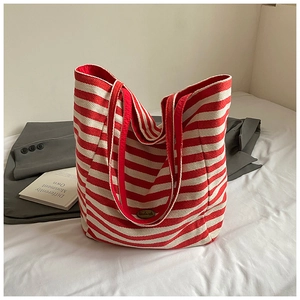 Macro detail of red and white striped canvas tote bag with a handmade label