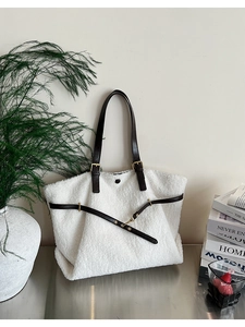 Detailed view of plush lamb wool tote bag with premium brown leather straps and metal buckle