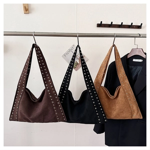 Three vintage tote bags with metal rivets in dark brown, black and caramel colors