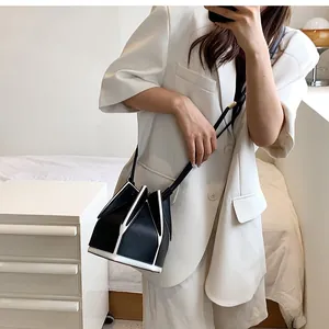 Close-up of contrast black and white bucket bag with geometric petal cutting detail