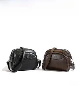 Detail view of multi-layer zipper compartments and texture on soft leather shoulder bags