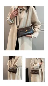 Detail of dark brown vintage crossbody bag with gold ring buckle and adjustable strap