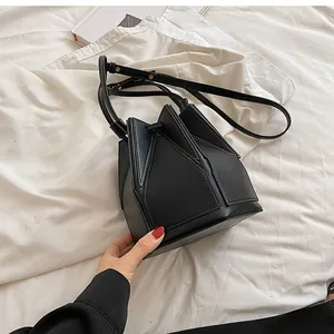 Detailed top view of black leather folding bucket bag with unique geometric star design