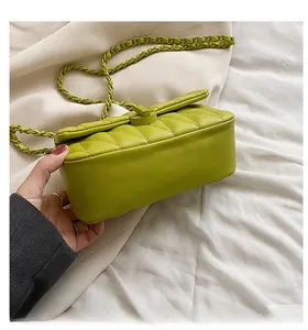 Close-up of lime green quilted leather crossbody bag with woven chain strap and stitching