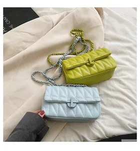 Close-up of small crossbody bags with V-quilted pattern and metallic T-lock detail